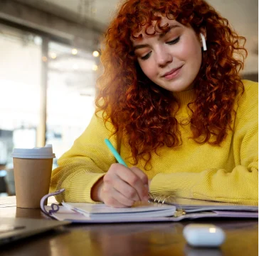 a woman writing and smilling